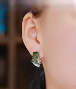Detail of moss agate ear cuff with trapezoid cut and silver scalloped setting on ear