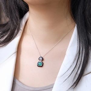 Vintage S925 silver necklace with emerald cut green gemstone on female model