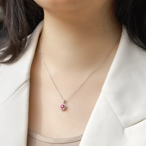 S925 sterling silver necklace with ruby sunflower pendant worn by a model in white blazer