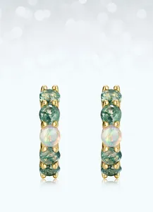 Macro shot of S925 silver earrings with green moss agate and iridescent opal stone inlay