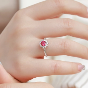 Luxury S925 sterling silver ring with a red ruby sunflower design shown on hand