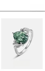 Detailed macro shot of a snake-shaped silver ring with teardrop-shaped green moss agate