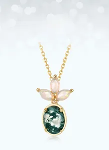 Macro detail of moss agate pendant necklace with opal stones in gold-plated silver setting