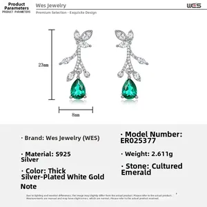 Close-up of S925 silver leaf earrings with marquise zircons and pear-cut emerald drop