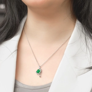 Elegant S925 sterling silver necklace with emerald cut green gemstone on a model