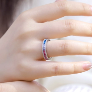 Rainbow gradient zirconia eternity ring in S925 sterling silver worn on a woman's finger