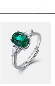 Macro di anello in argento con smeraldo ovale e diamanti laterali a forma di pera