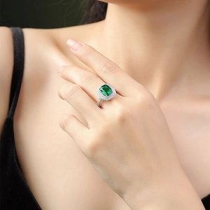 S925 silver ring featuring a square emerald-cut green gemstone with diamond halo on finger
