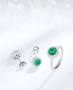 Detailed view of the S925 silver halo jewelry set with round emerald gemstones