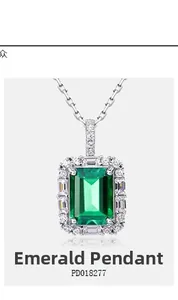 Detail of emerald cut green gemstone pendant with shimmering diamond halo on silver chain