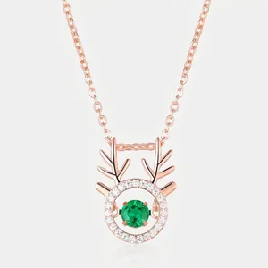 Elegant rose gold reindeer antler necklace with a shimmering green emerald gemstone pendant