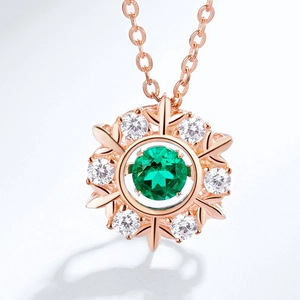Snowflake pendant necklace with green emerald gemstone in rose gold finish