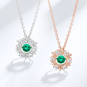 Snowflake pendant necklace set in silver and rose gold with round green gemstone