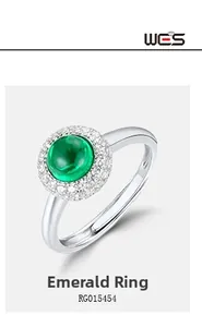 Detailed close-up of emerald ring with halo diamonds and adjustable silver band