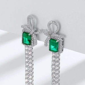 S925 silver bow stud earrings featuring emerald gemstones and dangling fringe tassels