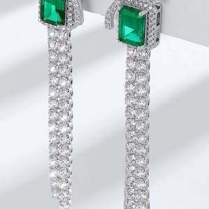 Luxurious S925 silver bow stud earrings with emerald-green stones and long diamond tassels