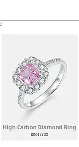 Close-up of pink cushion-cut high carbon diamond halo ring with micro-pave silver band