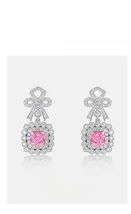 Macro detail of S925 silver bow earrings featuring pink cushion-cut cubic zirconia and pavé stones
