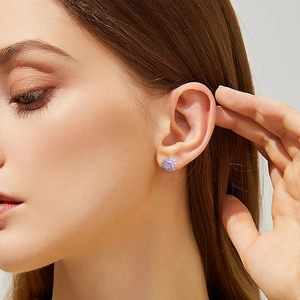 Luxurious S925 silver halo earrings featuring a square pink stone on an earlobe