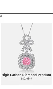 Detailed macro of pink radiant cut high-carbon diamond pendant with silver bow setting