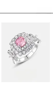 Detailed macro of S925 silver ring featuring pink cushion-cut stone and bow-knot detail