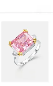 Close-up of radiant pink rectangular carbon diamond ring with side tapered baguettes
