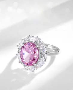 Macro view of ice-cut pink carbon diamond ring with oval gemstone and silver band