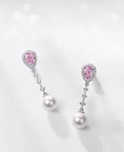 Detail of S925 silver earrings with pink drop-cut carbon diamond and elegant white pearl