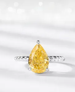Macro shot of S925 silver pear-shaped yellow diamond ring with twisted rope band