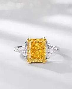 Macro detail of radiant cut yellow carbon diamond ring with three-stone setting design