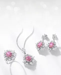 Macro detail of ice-flower cut pink oval gemstones set in silver necklace and earrings