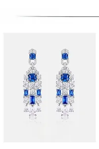 Macro detail of S925 silver blue spinel and high carbon diamond long tassel earrings