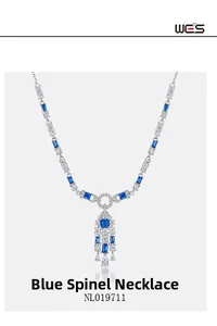 Detailed macro shot of vintage silver necklace featuring blue spinel and white zircon stones