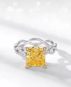Macro detail of ice-cut yellow carbon diamond ring with silver twisted band and pavé stones