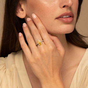 Pear-cut yellow diamond S925 silver ring with beaded band shown on female model