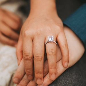 Close-up of a S925 silver radiant cut ring with a hidden halo and pavé-set diamond band