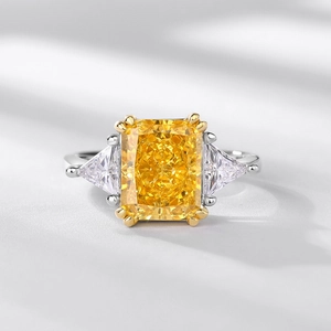 Radiant cut yellow carbon diamond ring with side triangle stones in a luxury design
