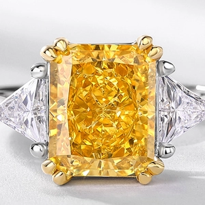 Elegant radiant cut yellow stone ring with triangle side diamonds on silver band