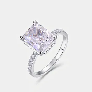 Luxurious S925 silver ring with emerald cut diamond and side stones on gray background