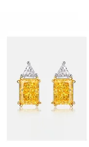 Macro shot of yellow radiant cut carbon diamond stud earrings with S925 silver claws