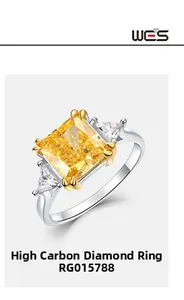 Three-stone ring featuring a yellow radiant cut carbon diamond with side triangle stones