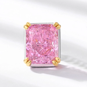 Radiant cut pink carbon diamond stud earring with dual-tone metal setting on grey background