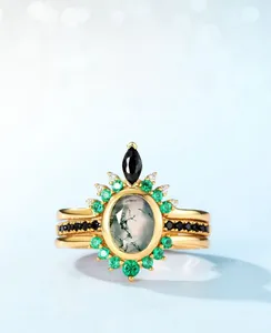 Detail of moss agate stacking ring set with green gemstones in gold-plated finish