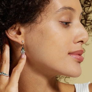 Macro shot of S925 silver earring with moss agate and V-shaped chevron ring on model