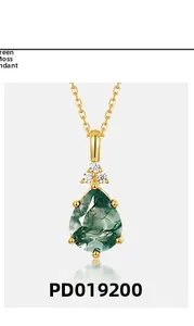 Macro detail of teardrop green moss agate necklace pendant with gold finish and zircons