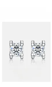 Macro shot of S925 silver moissanite stud earrings featuring a 4-prong ox-head setting