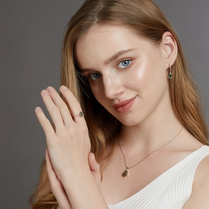Model wearing S925 silver jewelry set with green moss agate stones and rose gold finish