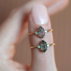 Elegant gold S925 silver ring featuring hexagonal green moss agate on a model's finger