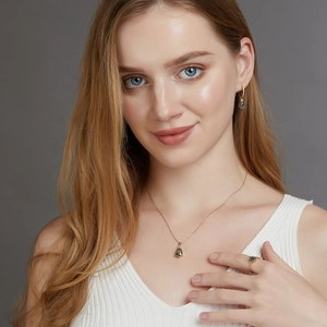 Elegant jewelry set with drop moss agate pendant necklace earrings and ring on a model