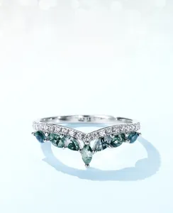 Macro shot of V-shaped S925 silver ring with marquise-cut green moss agate stones